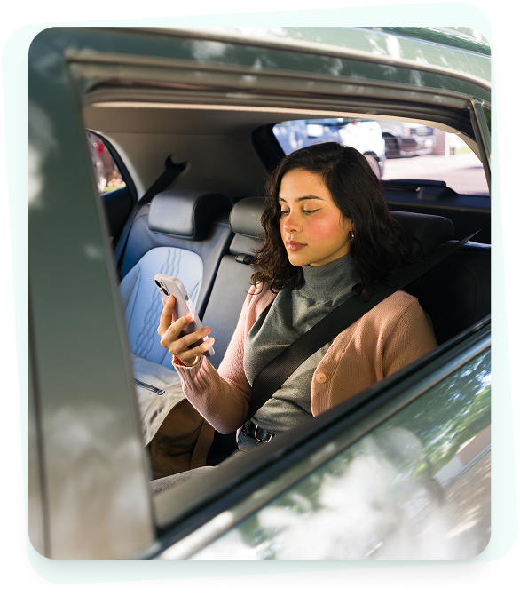 Passenger using phone in car